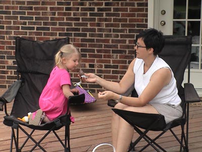 Emma and Nicole chow on chocolate eggs