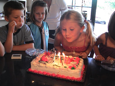 Emma blowing the candles out on her cake