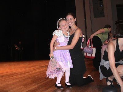 Emma on stage with her dance teacher after the show