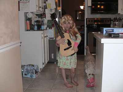 Emma dresses as Hannah Montana, showing of her new wig and guitar she received as Christmas gifts