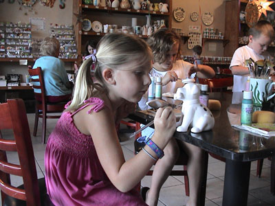 Emma enjoying painting pottery