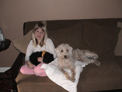 Emma cuddling with the two dogs