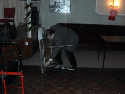 A 50 year old struggles to fold-up a table !