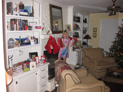 Emma standing in the den by the fireplace