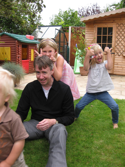 Nick playing with Emma and Olivia, the kids are giving Nick a WORK OUT