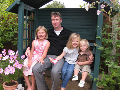 Nick with Emma, Olivia and Astin in the garden