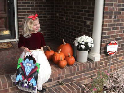 Emma by the front door and the pumpkins