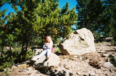 Emma wearing her bandana on a rock in Colorado