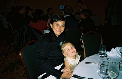 Nicole and Emma seated at the wedding dinner